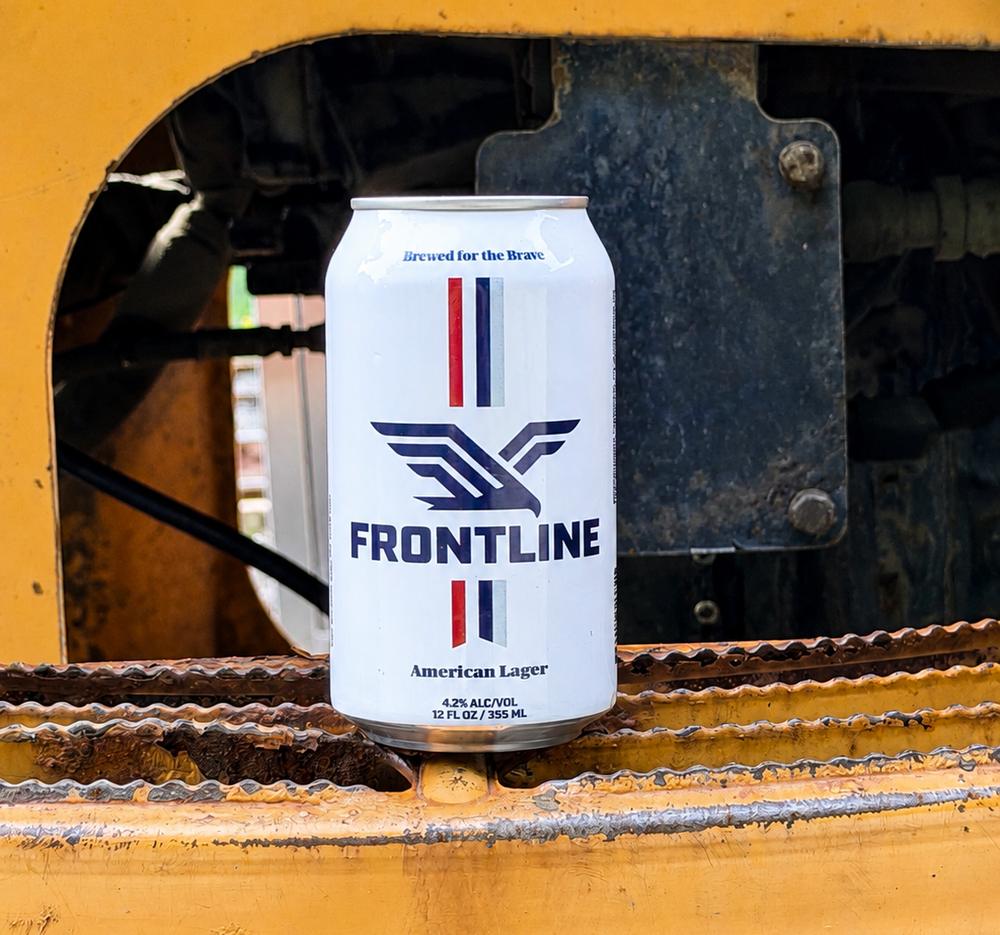 A Frontline can resting on heavy equipment