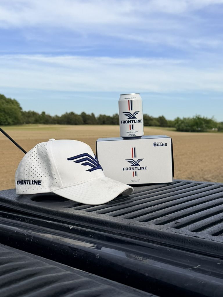 A Frontline hat and six-pack on a truck tailgate
